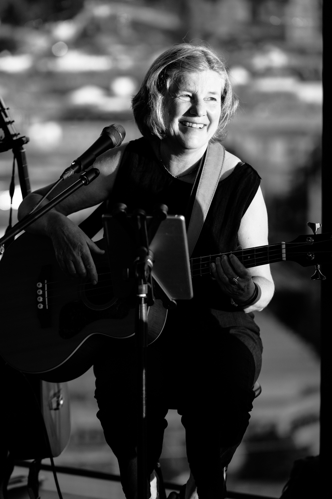Smiling member of Löffelzart playing acoustic bass during Artists’ Place at the hu:goes14 Rooftop Bar in Salzburg.